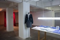 https://salonuldeproiecte.ro/files/gimgs/th-59_25_ Iulia Toma - From the blue coat to the flowery house coat, with a stop in corporate-augmented-reality, 2012 - installation, work table, mannequin, uniforms.jpg